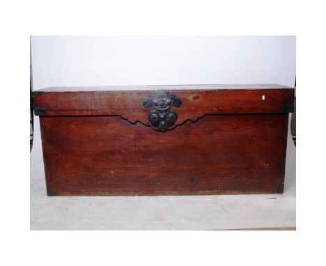 Large Chinese stained pine trunk, rectangular form, hinged lid, metal mounts and carrying handles, length 167cm.