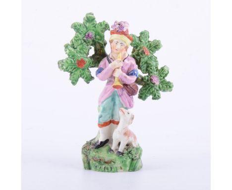 Staffordshire pearl glazed earthenware bocage figure of a piper, circa.1820, with overglaze painted decoration, modelled with