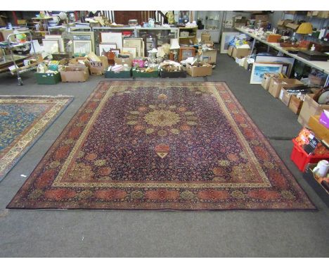 A blue ground rug with central floral panel and multiple borders, worn to edges, 365cm x 276cm