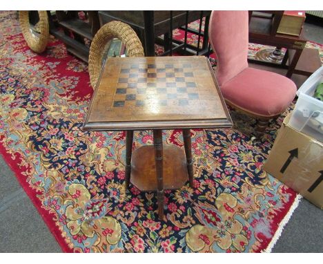 An Edwardian occasional table with chequerboard top, ring-turned supports to under-tier, 65cm tall