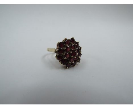 A 9ct gold garnet cluster ring. Size O, 5.8g