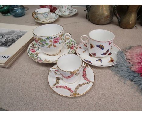 Three variously patterned Derby porcelain tea and coffee cups and saucers, butterflies and flowers (6)