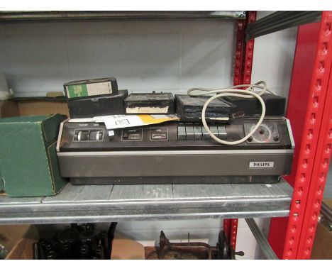 A Philips video cassette recorder with various tapes