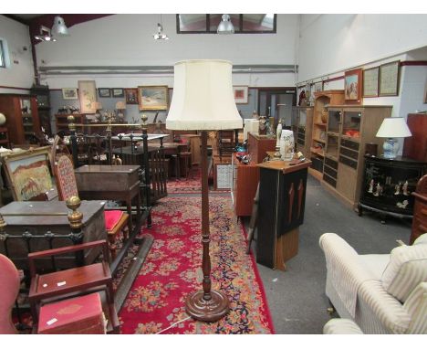 A mahogany standard lamp with fluted column, tasselled shade
