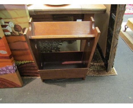 A medium oak book trough with under tier and pierced ends. A brass trivet on stand and windmill design letter rack (3)