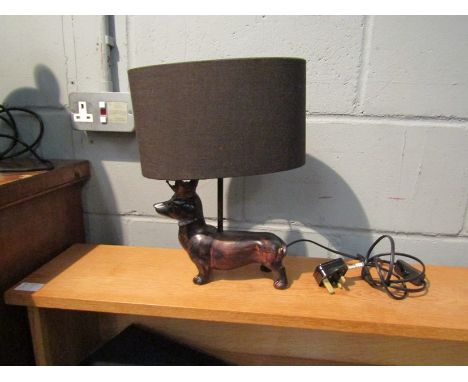 A table lamp as dachshund wearing crown, back leg restored    