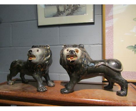 Two ceramic lions, repaired