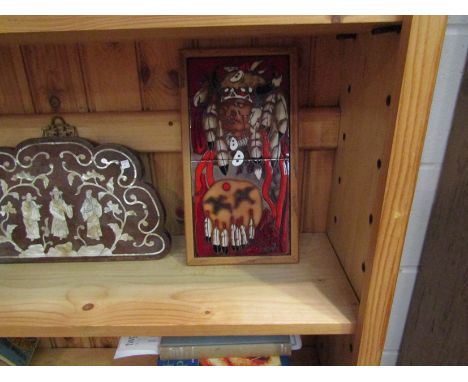 A framed Indian chief tile wall hanging, 33cm x 18cm