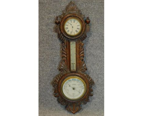 A late 19th century carved oak barometer. W.66cm 
