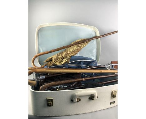 LOT OF VINTAGE WALKING STICKS, along with umbrellas and a stick/seat, contained in a vintage suitcase