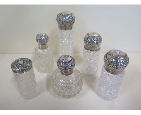 Six silver topped sent bottles, some with rubbed marks, approximately 2 toz in silver, some chips to glass, dents to top one 