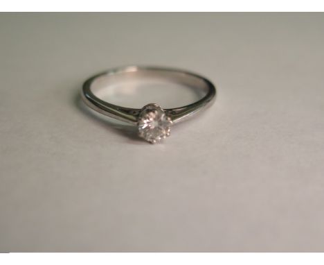 A solitaire 0.25ct diamond ring with 18ct white gold band, ring size Q, approximately 2.9g, with some signs of light wear 