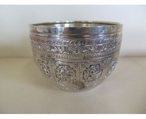 An Indian silver bowl, decorated with zodiac figures and animals, stamped with English import marks, with glass liner, approx