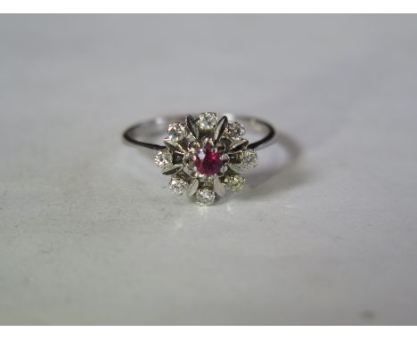 An 18ct white gold diamond ruby cluster ring, size T, approx 4.5 grams, overall good condition, some abrasions 