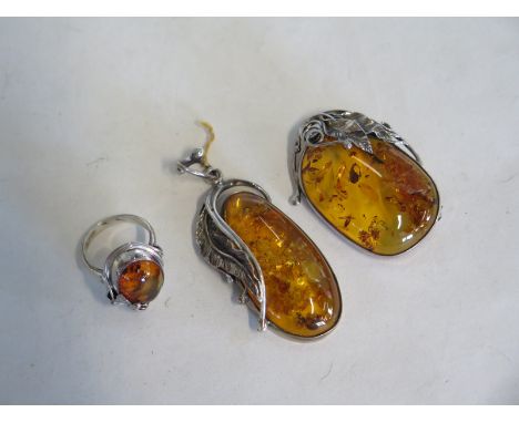 A silver and amber ring, brooch and pendant - pendant 6cm long 