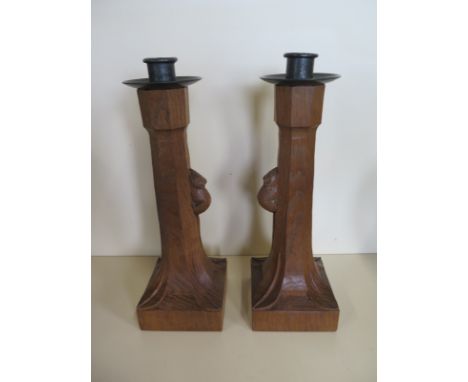 A pair of Robert Thompson of Kilburn Mouseman carved oak candlesticks with wrought iron pans and a square bases - 29cm tall -