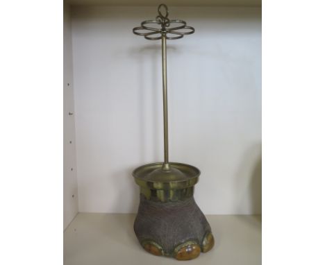 A taxidermy Elephant foot and brass stick stand, circa 1920-30, approximately 85cm high overall, in good condition but with s