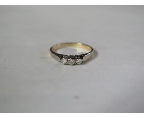 A three stone diamond ring with 18ct gold band, ring size K, 1.7g 