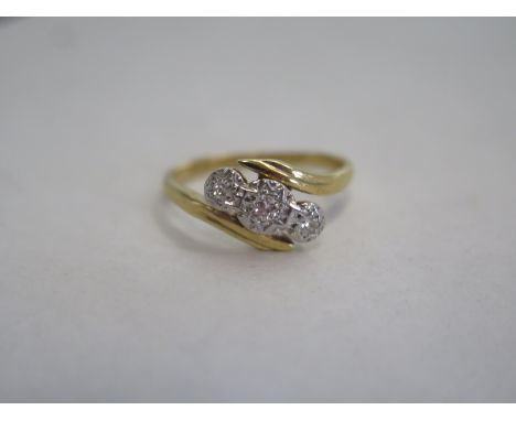 A three stone diamond ring with a an 18ct gold band, ring size K, approximately 2.8g 