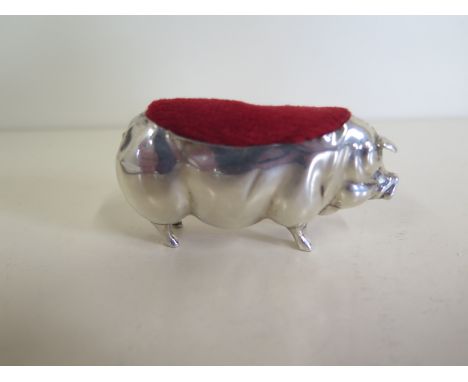 A silver pig pin cushion 7cm long, Birmingham 1920/21, maker L & S - some denting to body but intact 