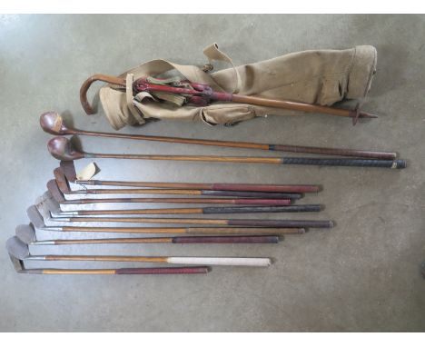 A collection of eleven hickory shafted vintage golf clubs including A Neild Prestwick special in a canvas bag with bamboo sho