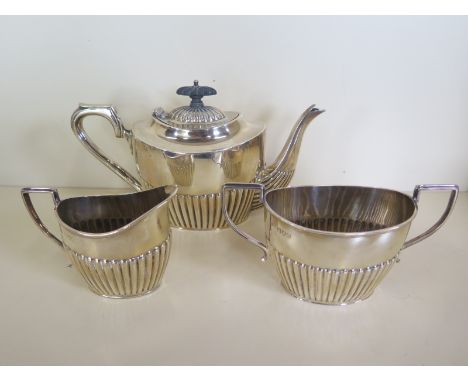 A silver three piece near tea service, teapot hallmarked Birmingham 1897/8, the sugar bowl and milk jug London 1897/8 - total