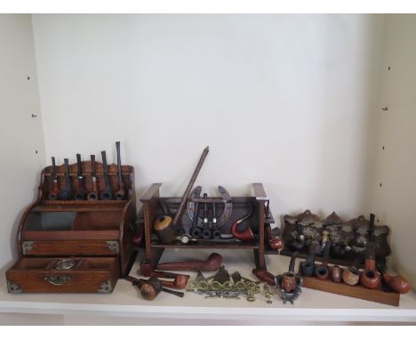 A good collection of smokers pipes with six pipe stands/racks - and three tapers, 34 pipes in total, and a cigarette holder 