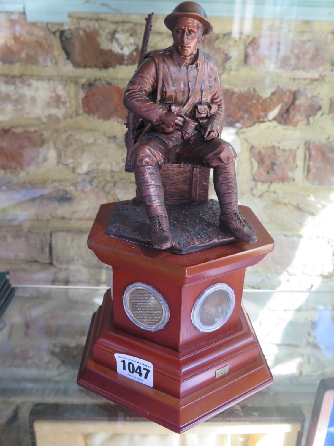A commemorative figurine of a WW1 British soldier with six pennies to