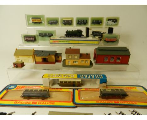 An N Gauge Railway Layout comprising a GWR Prairie 0-6-0 locomotive with ten boxed wagons and three boxed carriages approxima