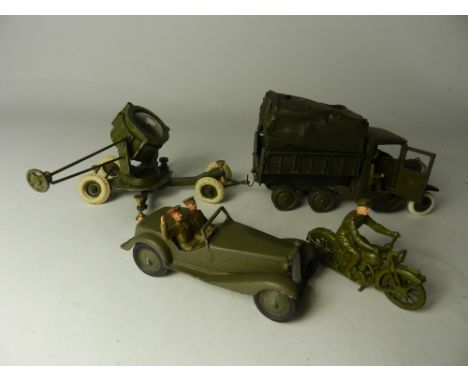 A group of restored Britains army vehicles to include a six wheel covered wagon with driver, a working searchlight with a mat
