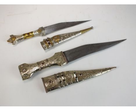 A Turkish dagger and scabbard, the silvered hilt decorated in yellow metal and with semi-precious red stones, blade length 15