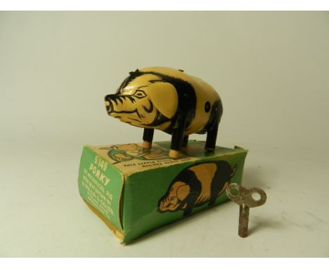 A boxed Wells Brimtoy tinplate toy pig with operating clockwork mechanism with key.