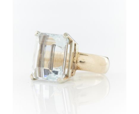 14k yellow and white gold aquamarine ring set with large step cut aquamarine (approx. 12 carats) in a white gold basket on a 