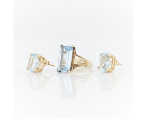 14k yellow gold cathedral style ring set with step cut blue topaz (approx. 5.6 ct), marked 14k along the interior. 14k yellow