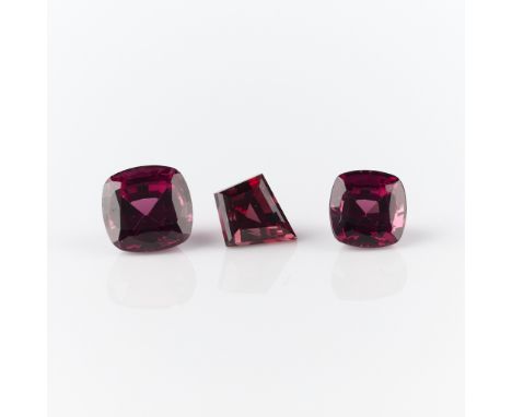 Group of three Rhodolite garnets. One cushion cut weighing 1.40 carats, one cushion cut weighing 2.10 carats, one kite weighi