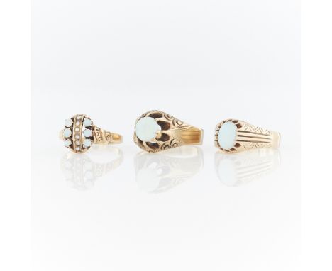 Group of three opal and gold rings including:One 14k yellow gold ring set with six small opal cabochons and six seed pearls, 
