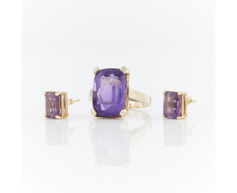 14k yellow gold cathedral style ring set with a cushion cut amethyst (approx. 6.84 ct), marked 14k MB along the interior shan