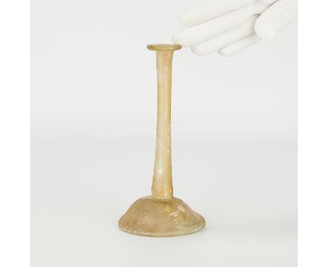 Roman glass balsamarium or unguentarium, ca. 1st-3rd century CE. With a truncated, conical body, a tall, tubular neck, and an