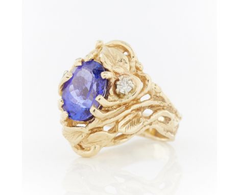 Maraya 14k gold ring of swirling vegetal form set with an oval tanzanite and one small full cut diamond. Marked Maraya and 14