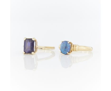 Group of two yellow gold rings including:One 14k yellow gold ring set with step cut iolite, marked 14k along the interior sha