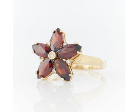 14k yellow gold ring set with five marquise cut garnets arranged in a flower pattern, one small full cut diamond between each