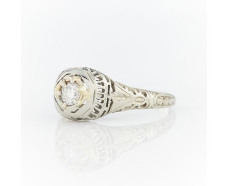 18k white and yellow gold filigree ring set with one central brilliant cut diamond (approximate diameter 3.5 mm). Marked 18k 