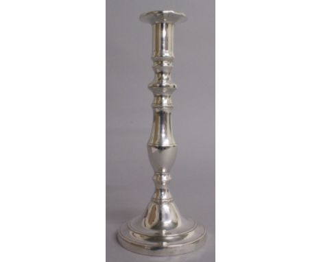 A CIRCULAR CANDLESTICK with loaded base. 9.5ins high.