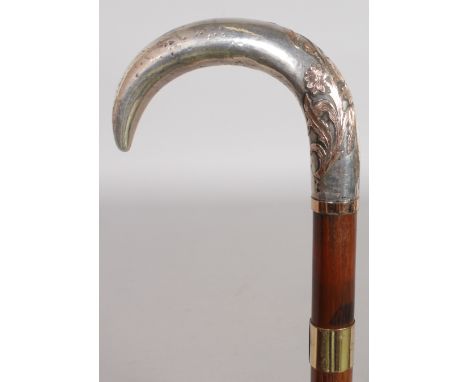 A SILVER AND PINK GOLD ROSEWOOD CROOK STICK. Date: 1890.  Country: French. A well fashioned silver crook handle with detailed