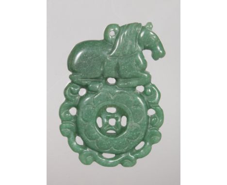 A CHINESE GREEN JADE HORSE ON A SPHERE PENDANT.