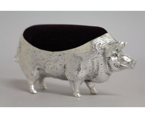 A LARGE SILVER PLATE NOVELTY PIG PIN CUSHION.