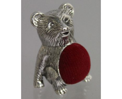 A SILVER NOVELTY TEDDY BEAR PIN CUSHION.