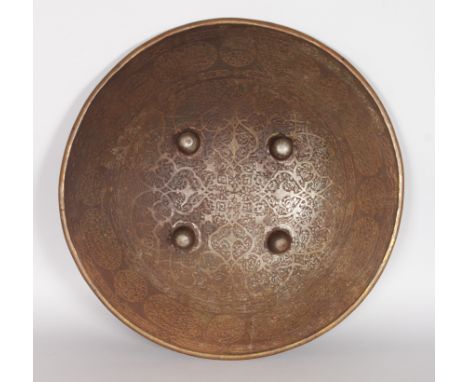 AN INDIAN CIRCULAR SHIELD, etched overall with flowering decoration and circular and oval panels near the rim with calligraph