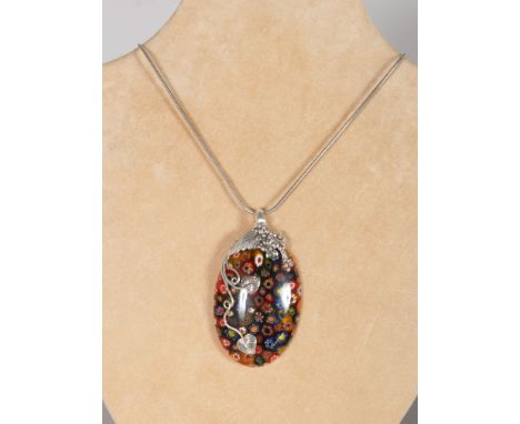 A LARGE MILLEFIORI GLASS SILVER MOUNTED PENDANT on a chain.
