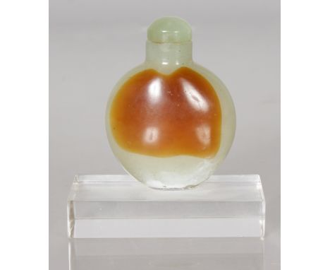 A JADE SNUFF BOTTLE AND STOPPER on stand.